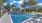 a tennis court with a fence and trees