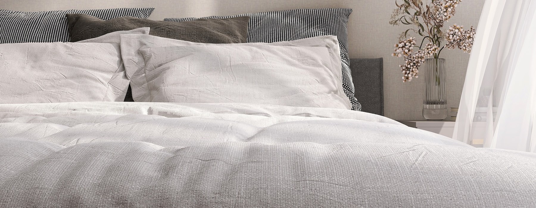 A bed with a white sheet at The Preserve at Travis Creek apartments in Austin.