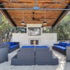 an outdoor fireplace area with couches and chairs
