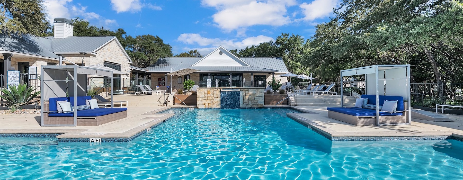 a swimming pool with a house in the background