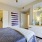 a bedroom with a bed and a mirror