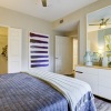 a bedroom with a bed, a dresser and a large mirror