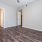 a room with a wood floor and a ceiling fan