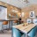 a room with a table chairs and a chalkboard
