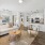 A living room with a large dining table at The Preserve at Travis Creek apartments in Austin.