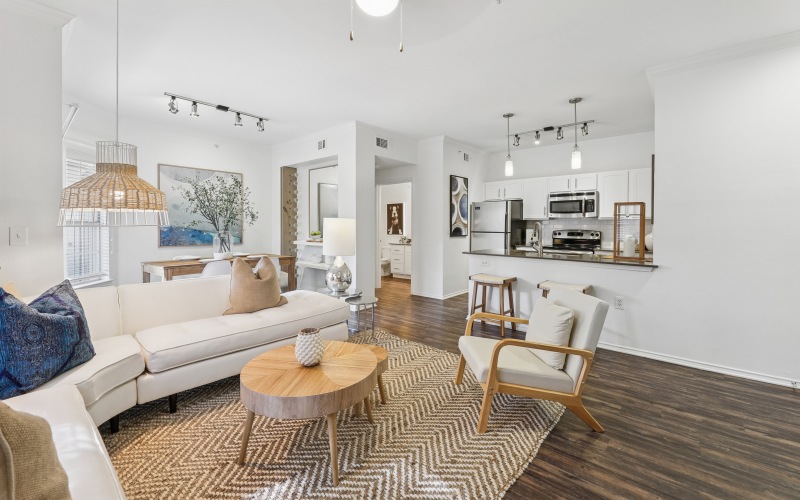 A living room with a large dining table at The Preserve at Travis Creek apartments in Austin.