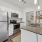 a kitchen with stainless steel fridge, microwave, and stove