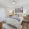 a room with queen size bed, and natural lighting