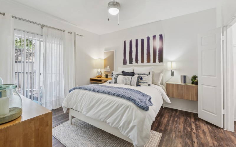 A room with queen bad and balcony