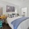 a bedroom with a queen bed and spacious connected closet