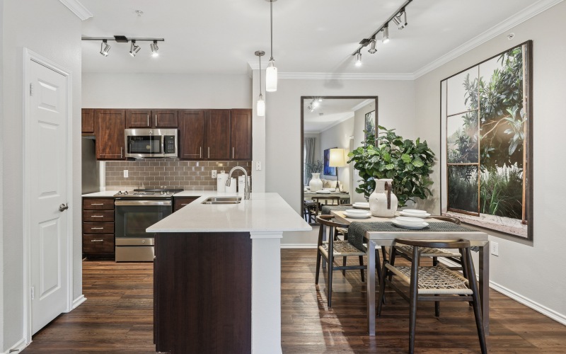 A Kitchen With Stainless Steel Appliances and dining room table