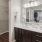 A bathroom with vanity and closet