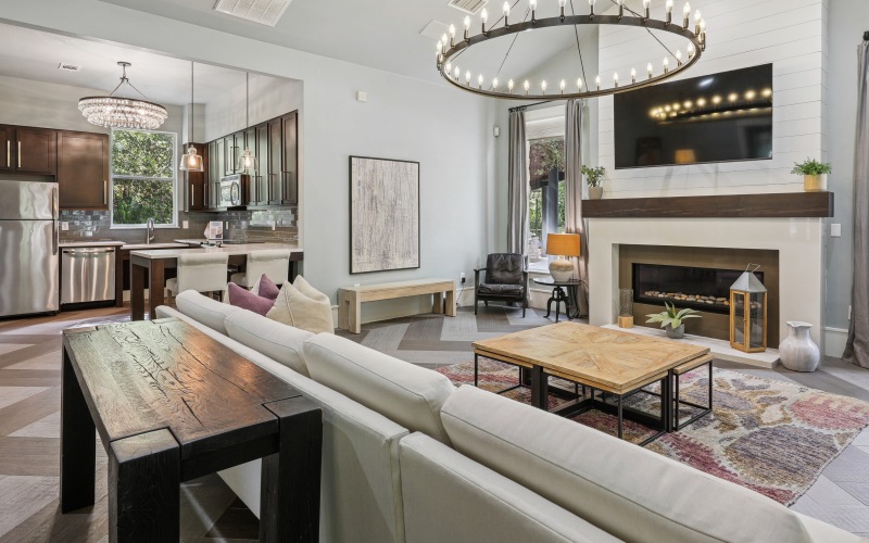 A room with kitchen, TV, fireplace, and large sofa