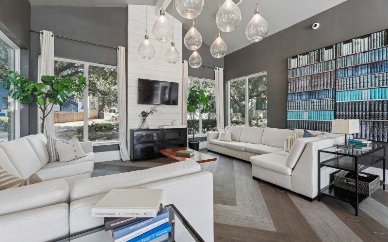 A room with large white sofa and natural light